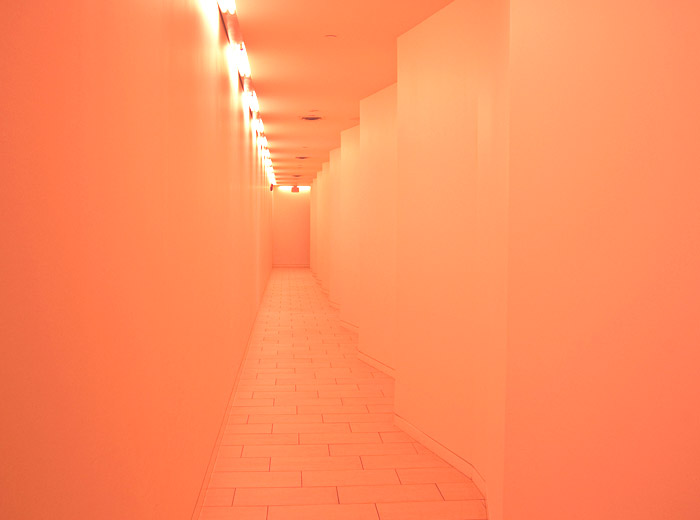 Yyoga Richmond yoga studio modern architecture orange hallway with curved wall pattern